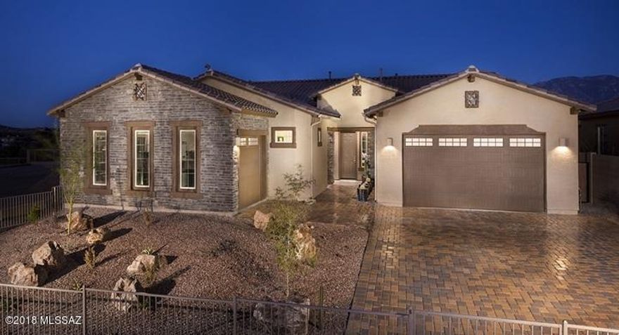 This gorgeous Revelation MODEL is now for sale, able to close the end of August! Home features our ''Next Gen'' home w/in a home w/attached separate living quarters! Main living area has 3 bedrooms and 2.5 baths, while the Guest space offers 1 BR, 1 bath, LR & kitchenette! The main area boasts of a large great room and gourmet kitchen w/large island dining area looking out to pool & Mountains! Granite c-tops in kitchens, w/quartz  in all baths! Homesite backs to common space & east Catalina Mountain view! Upgrades are many: Super Kitchen w/Monogram appli, Upgrd Tile everywhere, FP, automated window cvrngs in Great rm & MBR & wood shutters, Spa shwr, 2 tone paint, 12' SGD, Upper Deck, LED lights & more! Public report available on AZDRE website.Call ahead 1 hr:800-864-1055 for appt.