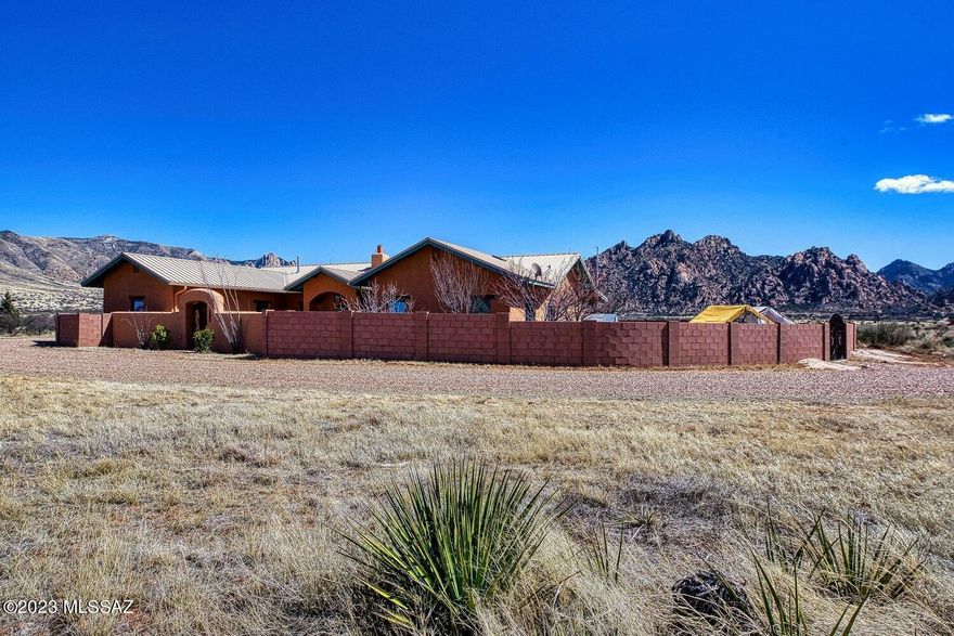 EXQUISITE, ELEGANT, EXCEPTIONAL.  Stunning Dragoon Mountain Ranch estate artfully designed by Benny Gonzales & laid out at the foot of the historic Dragoon Mountains for unparalleled, majestic views.  This publish-worth home has had the following enhancements:  5' high block wall surrounding the home, decorative courtyard gate, perimeter fencing, 3 snake-proof gates on backyard wall, new water pump & cabling to a depth of 950', 1600 gal water storage tank, prof graded & modified horseshoe driveway, AB base driveway material followed by Colorado Brown gravel, arbor installed, partitioned & insulated garage w/ mini split system for art studio, 2 new garage doors, new cell phone booster & new 2nd RV outlet w/ new 50 amp outlet for a total of 2 full hookup locations. More in ''SUPPLIMENT'' tab Main home has dual air conditioning with separate thermostats.  High end interior enhancements include: new granite countertops in kitchen, whole home interior paint and concrete floor refinishing. 1 BR, 1 BA adobe brick guest house with full kitchen including refrigerator.  3 BR, 3 BA in main home, 1 BR, 1 BA in guest home.  Luxury country living at it's finest!