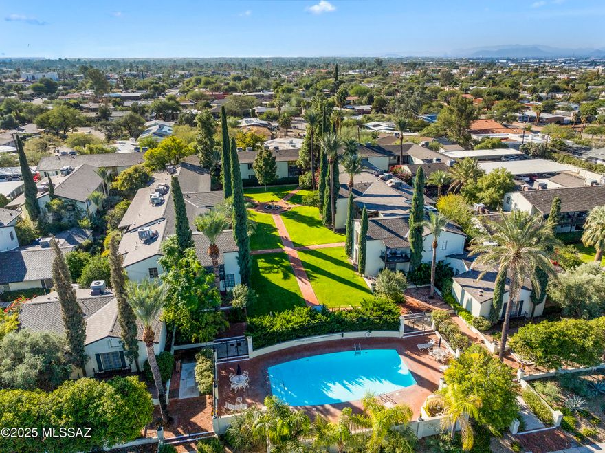 Own a piece of Tucson's history with this charming Sam Hughes El Encanto home, listed on the National Register of Historic Places. Set amidst meticulously landscaped grounds, this property features lush Italian cypress, palm trees, and evergreens—evoking the elegance of 1940s Southwest resorts. Enjoy a sparkling heated pool and red brick walkways, all within a serene, private oasis.

Located just minutes from the University of Arizona, Downtown Tucson, trendy restaurants, nightlife, museums, and shopping, this premium ground-floor unit offers both convenience and tranquility. The expansive backyard is a rare find, with no units, streets, or walkways behind, providing maximum privacy. Inside, the spacious dining room opens through French doors to a south-facing patio, perfect for enjoying year-round sunshine. The home boasts extra-large ceramic-tiled living areas, two generous interior hall closets for ample storage, two full bathrooms, and large bedrooms with premium laminate flooring. The master suite includes a walk-in closet for added convenience.

A unique blend of historic charm and modern living, this home offers a truly special lifestyle in the heart of Tucson.