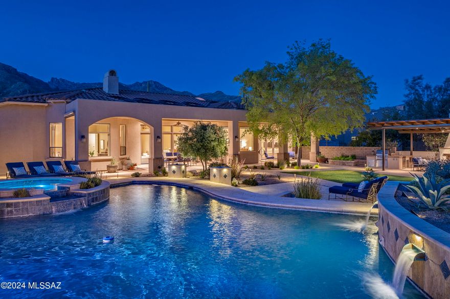 Nestled within the coveted gated community of Ventana Reserve, this Santa Barbara styled AF Sterling residence seamlessly integrates with its desert surroundings while showcasing a meticulous blend of textures and elegant finishes. The arrival sequence captivates with its embrace of the native landscape, juxtaposed against the timeless appeal of the home.

Upon entry, the grandeur of the living room unfolds inviting natural light to cascade through walls of vertical glass, creating an atmosphere of airy expansiveness. The kitchen, adorned with custom millwork and contrasting wood tones, is complemented by granite countertops while fitted with top-end stainless steel appliances. The custom-tailored breakfast bar features an array of service counter space, acting as a focal point, with the adjacent dinette opening onto a spacious family room, offering both functionality and aesthetic appeal. 

Neutral flooring lines the interior, threading the living spaces together, while providing continuity to the overall design aesthetic. The floor plan, while open, features a split bedroom make up with the owner's suite privately sequestered on the southwest end of the residence and the secondary bedrooms situated on the east. 

The expansive backyard offers a series of elevations and patios, with the exterior living spaces designed for year round entertainment. Located beyond the extended covered veranda is an outdoor kitchen with covered cabana and complete with a barbecue station and ample counter space. Layers of elevated patios create the framework for the stunningly designed pool and spa, acting as the centerpiece of the backyard entertainment, where every comfort has been considered and detail meticulously crafted. The result of this experience is a home that offers a sense of ease to enjoy the Arizona lifestyle.