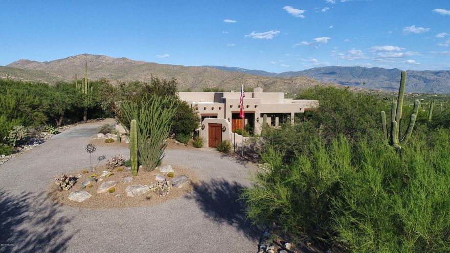 Tucson Association of Realtors Home Tour Winner!  Amazing 3 bedroom 3.5 bathroom + office/den with a 3 bedroom/2 bathroom guest house nestled in the foothills of the Catalina Mountains.  Well appointed kitchen has knotty alder cabinets, gorgeous chiseled granite counter tops and stainless steel appliances.  Private master suite with exit to pool/hot tub in the backyard oasis.  Pool bath has a wooden sauna.  2nd bedroom has two murphy beds that can also double as desks.  Entertain guests in the large great room or open the French doors and spill out onto the covered patio with firepit and elevated panoramic view past the many saguaros on your 2.39 acres.  Don't miss the video and the 3D virtual tours of the main and guest houses under the photos tab.  The oversized... The oversized 3-car garage with epoxy floors and freshly painted walls has an abundance of shelving and plenty of room for wood working tools while all 3 bays are occupied. 

AMENITIES:
All rooms- sand blasted wood doors
Guest bedroom-large walk in closet, private guest, television/dish wired, fan, mountain views, 
Second bath-double sinks, tile/glass block shower, drawers and tilt outs in cabinets, skylight, led lighting
Office-built in bookcases, credenza, executive desk, file drawers, with built in lighting, television/dish wired, fan
Family room- gas fireplace, built in shelves, wired for fan, lighted plant shelf, lighted television shelf, surround sound wired, double door access to patio, wall of window doors, vaulted beam and plank ceiling, mountain and valley views
Kitchen- granite with chiseled edge, roll out drawers in all lower cabinets, floating lazy susans (no pole in the middle, always level and easy!), large walk in pantry with custom adjustable shelving, stainless appliances, 5 burner gas range, stainless sink with touch sensor faucet, large breakfast bar, wired for television/dish, custom, moveable work island with wood block top, spice drawer, trash bin, paper towel holder, shelves pull out additional work space, desk area with shelves, skylight, mountain and valley views, under cabinet and under breakfast bar lighting, led lighting
Dining nook- French door access to patio, views
Laundry- utility sink, cabinets, hobby/sewing desk, equipment closet, wired for television/dish, gas dryer, folding table, skylight
Powder room- pedestal sink, led lighting
Second guest room- twin murphy beds, shelves custom fit, large closet, fan, wired for television/dish 
Master bedroom- gas stone fireplace, fan, wall mount television wired for dish, angled for mountain and valley view windows
Master bath- jetted and heated spa tub, double sinks, led lighting, built in hamper, drawers, tilt outs, full led lighted separate vanity, large walk in shower with high and low shower heads, access to patio/pool, skylight, mountain views, valley views, television/dish wired.
Master closet- large, led lighting, lots of built in shelving
Pool bath- four -six person sauna, enclosed shower, stool, sink, heated and cooled, skylight
Patio-stereo speakers, gas log firepit with benches, gas grill stub, views, views, views, wired for fans, exposed granite surface, pebble tec pool with water fall, jacuzzi, in floor cleaning system and gas heater, native plantings, low voltage wiring, drip system.
 In General- wide halls, led lighting In halls, water softener, whole house water filter, utility sink in garage, cabinets, cabinets, cabinets and shelves in garage, 220 wiring, wired for emergency generator power, separate secured yards, code garage door openers, monitored alarm with motion detection, windows and doors, programmable thermostats, wood blinds, security lighting, two service doors in garage, extended length garage, extra wide, concrete garage pad entry, chip sealed drive, exposed granite walks and sitting pads, solid wood front entry door, private courtyard, gated entrance, tile and laminate throughout.
Guest house- 
Master bedroom/bath- large, (fits king size bed and furniture easily) fan, mountain views, walk in closet, skylight, tile walk in shower, double sinks, separate shower and stool area, lots of cabinet space, tilt outs, medicine cabinet, linen closet. Kitchen- garbage disposal, dishwasher, gas range w/self cleaning oven, exhausted hood, lazy susans, under cabinet lighting, large pantry. Second bath- tub with shower, separate shower/tub and stool space, tilt outs, medicine cabinet.  Second and third bedrooms- large closets, built in desks and cabinets and drawers, fans. In General-  tile throughout, washer and dryer closet space stubbed for gas, wired for television/dish in all rooms, plumbed for softener, extra large outside storage, hard wire alarm monitored, door, windows and motion. programmable thermostat, wood blinds, hall skylights, beamed and plank ceiling in family/ kitchen area, gas stub for gas grill, wired for fans on patio ,lighting on patio, security lighting, large patio with mountain views, gas heat, drip system, native plantings, enclosed, secure yard.
