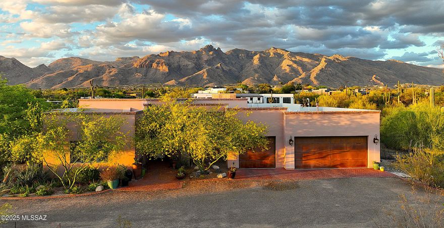 Stunning Catalina Mountain views & timeless territorial charm sits on an elevated 1.75-acre Foothills lot w/sky high beamed ceilings.  Luxurious custom home has outdoor living w/generous covered patios, an outdoor kitchen, fireplace, Talavera fountain & extended brick pavers. Beautifully appointed interior features saltillo tile, alder cabinets as well as 8' alder doors, a Sonos sound system, spacious greatroom with dramatic fireplace and wall of steel casement windows framing the mountains. Gourmet kitchen offers Thermador SS appliances, a 90-bottle wine fridge, mesquite island & large walk-in pantry. Primary includes dual vanities, walk-in shower and huge closet. Enormous 3-car garage w/bonus storage room and unbeatable Foothills location complete this exceptional home.