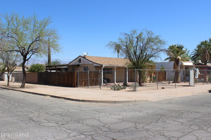Cute home on a spacious corner lot in need of some TLC to bring it to its full potential. Built in 1945, this is a charming mid-century character home. 2 bed, 1 bath and was completely repiped in March 2021. There is a spacious Arizona room with a space for laundry and a workshop area - could be converted into additional square footage for the home if desired. Includes two double gates to the back yard, an enormous back patio and a tandem 2-car carport. Several sheds on the property provide all the storage space you'll need. The entire lot is fenced, front and back. This cute home is located in a quiet neighborhood just south of Reid Park. Many of the homes in the area are being updated and property values are solid and rapidly increasing - just take a look at the comparables!!