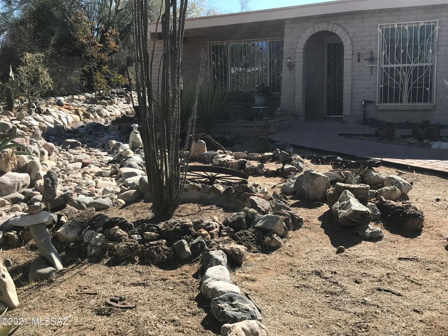this semi-custom 4 bedroom north east home offers so much. Ceiling fans all 4 rooms, 3 bathrooms, 400 sq ft  entertainment wet bar with covered area for freeze/ refer, water for Ice maker, 2 closets, reinforced mounting for large TV, soundproof in all walls bordering house.Family room w/fireplace.  fake dog house conceal. 2 car garage wi/insulated door, 220v outlet. 3 car walled carport (totally shaded). 160 sq. ft. workshop 220v outlet pegboard shelving and workbench. walled back yard with  metal riser for additional security/privacy/pets. 19,000 gal swimming pool with diving board. Pentair Superfllow VS multiple speed pool pump w enclosure, pentair Triton TR60 sand filter, Kreepy Krawly all new 2016. water capture, 12x16 Ramada, granite kitchn counters custom pullout cabs/full range.
