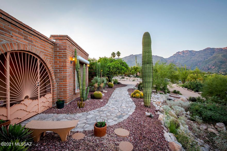 Nestled atop a hill in iconic Cimmaron Estates, this territorial home is adobe built with panoramic views on a very quiet cul-de-sac. Enjoy the sunrise in the east while gazing at Sabino Canyon. Beautiful sunsets await you on the back patio as well as city lights at night. The home was remodeled in 2015 with
quality upgrades ranging from granite kitchen and bathrooms, stone tile showers, and concrete Rojo floors. This home offers wonderful flexibility as you could turn the den into a 4th bedroom or use the bonus room for creativity. The large master has a double vanity bathroom & a shower for two. It also has a door to its own private patio with access to the pool. Come experience these lush grounds, see yourself doing laps in the pool and soak in just how comfortable this home feels.