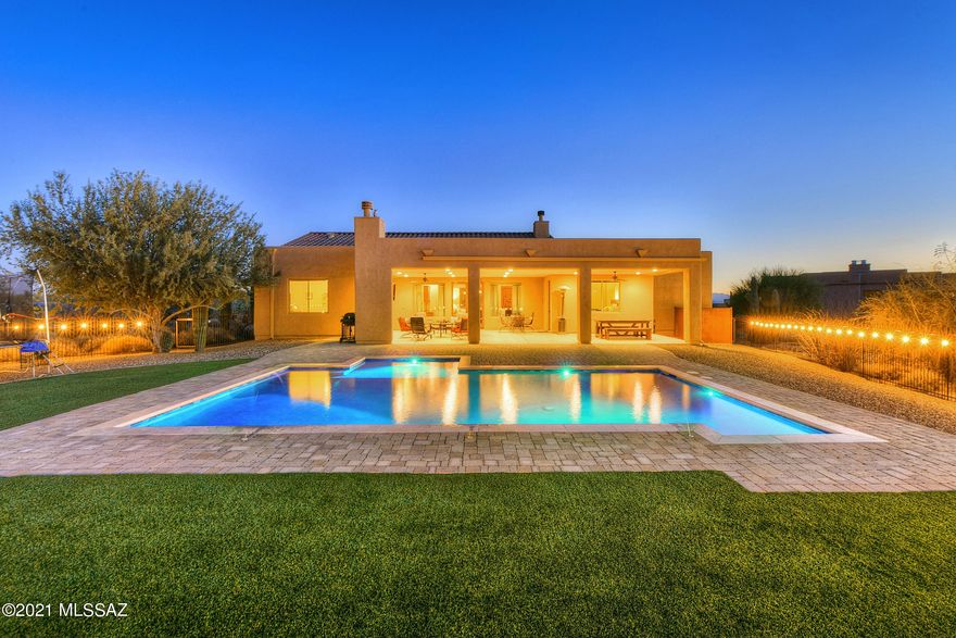 Seller shall entertain/counter offers from $775k-$800k. Private setting but close to city amenities. Custom 4 bedroom, 3 bath,  3,072 sqft. home sits on over 1.02 acres lot backs to open space dotted with Majestic saguaros, beautiful sunset and mountain views of the Tortolita Mountains. Constructed in 2015 in classic Southwest Contemporary style, the main residence features elegant design features unique to Desert Mountain living, masonry gated courtyard with custom steel double doors, travertine floors through out, two gas fireplaces (great room & patio),  8 foot Alder interior doors, over-sized four car garage. The home features a balanced free flowing design from the great room featuring a 13 foot ceiling height with wood beams, spacious laundry room with custom wallet cabinets, granite counter top with sink, with two flexible rooms off of the great room,  Double French door leads to the outdoor living space offering a relaxing vibe including outdoor fireplace, extended patio with pavers leads to pebble-tec pool with fountain spray. Everywhere, windows and glass doors allow bursts of natural light to soften and envelop the spaces and connect them with the outdoors. The meticulously designed chefs' kitchen features built-in Decor stainless steel appliances, 6 burner gas cooktop, massive island with sink, granite slab counters, walk-in pantry, and stunning knotty walnut custom cabinetry with crown molding. A gracious owner's suite with a huge master bath, two executive height vanities, walk in shower with travertine tile surrounds, and garden tub.  Secondary bedrooms share a jack n Jill bath, fourth bedroom near a powder room with a shower. The current owners have been loving stewards that created an inviting retreat for entertaining and celebrations.