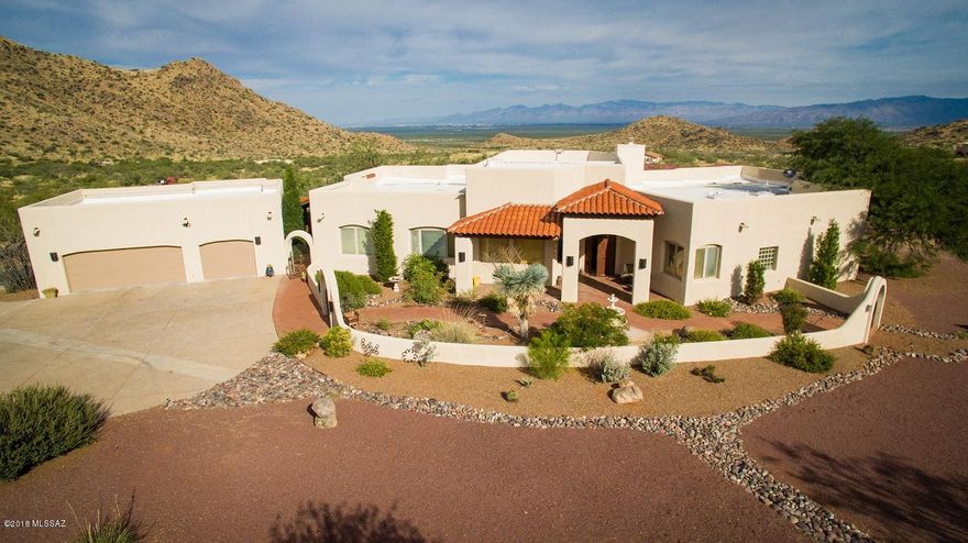 Stunning custom 10 acre (2 x 5AC lots) equestrian estate on paved road w/access to state land 200yds & Coronado Nat. Forest 0.5m. Spectacular 360 degree mtn & city light views! No HOA! 2x6 construction w/R19 batt insulation. 3Multiple use custom metal buildings totaling 3,032sf! SO MANY STUNNING HIGH END features - SEE FEATURE LIST (under Documents), DRONE VIDEO,VIRTUAL TOUR! 6 stall mare motel w/large coral.Huge metal building/workshop/2 car garage w/three 12ft roll-up doors,110/220 AMP&water, RV parking/storage.Large custom 16ft high 2 oversized stall barn w/adjacent tack room+large coral.4 acre turnout + round pen.1 covered & 1 uncovered RV parking w/2 separate hook-ups.1982sf guest house plans convey.Room for potential arena,etc.New PRIVATE well! Seller added $170K of improvements.... 4 oversized bedrooms & 1 oversized office (could easily be 5th bedrooms), 4 large ensuite bathrooms! Rough-sawn antique beam & plank living room ceilings, 1700sf wrap around porch w/rough-sawn antique barn beam & plank ceilings (from antique barn), custom mesquite cabinetry w/saguaro rib accents, oversized arched cedar doors, chiselled edge granite slab tops, huge master walk-in shower w/triple shower heads, 3 master sinks, custom cut glass mirrors, 2 large master walk in closets, pantry room, large office w/custom built-in cherry cabinetry, desks. Adobe brick built-in barbecue w/spit & double grill, fire pit, low E dual pane PELLA windows with removable glass for cleaning. Custom wrought-iron gates, fencing. Majestic high ceiling entry porch with custom chandelier....and so much more. MUST SEE FEATURE LIST, DRONE VIDEO & VIRTUAL TOUR. 8 carport spaces include: 18ftx36ft RV covered space & 36ftx36ft mare motel area.Multiple use !5 garage spaces include 3 car garage + 2 car 18x36 garage. Award-winning Vail schools.
