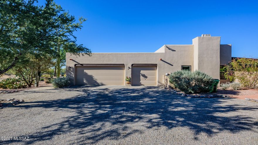 Beautiful well kept Santa Fe home located on huge lot for privacy and tranquil desert living! Recently renovated, New doors and screen doors throughout, remodeled both bathrooms, new jacuzzi and gas fire pit lighting. All cabinets have been resurfaced, Master bathroom remodeled, New skylights, fans and light fixtures. All new Anderson windows. Roof recently recoated along with the casita as well.  Home also includes paid for solar , three car garage, and extra shed for storage! Located in Tucson's pristine Northwest side, This home will not last long!