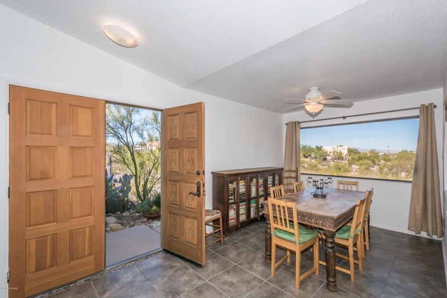 This is a complete view property! From inside and outside the house, there are stellar mountain and panoramic views. It is a true western home with a big rock fireplace, humming birds, butterflies, wildlife and trails close by. It is very convenient to the Sweetwater Preserve, downtown, the University of Arizona etc. The home is light and airy with great picture windows framing the views and big skylights adding natural light. The kitchen was remodeled less than two years ago and it features granite counters and granite back splashes, stainless steel appliances and more. All of this on an acre plus of land on a cul de sac tucked away for beauty and privacy.