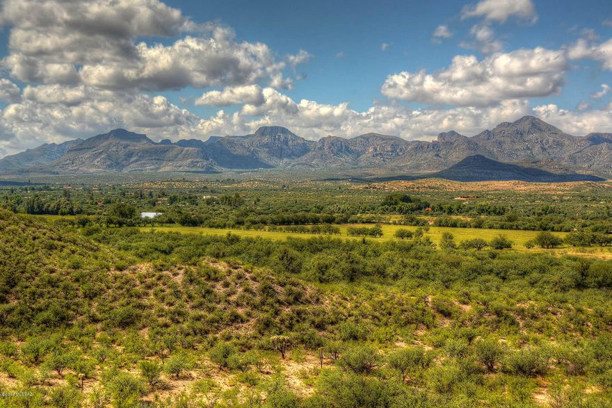 Beautiful 1232.92 acre So. Az. ranch with both level irrigated and high desert pastures, paved entry roads, a stunning 1930's era adobe main home/grounds, approx. 1838 ft of I-19 frontage road, all straddling approx. 1.2 miles of the Santa Cruz River near Tubac Golf Resort. 1359.5
acre/feet of IGFR water rights (145 of 312 acres currently irrigated from 2 primary irrigation
wells). Stunning masonry/stucco entry wall, mature trees & irrigated lawns circle 6484 sq/ft,
7BR, 4.5BA main home w/tiled roofs, hardwood floors, basement, hacienda patios (surrounding pool), private pond. Detached 4 car garage, guest and caretaker houses. Farm & ranch
equipment available. Adobe barn w/metal roof, shop, outbuildings. A classic Santa Cruz River ranch just 38 miles S. of Tucson.