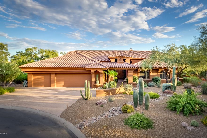 Resort living in Gated Tucson National Estates. Updated in 2007 this exquisite home is a perfect blend of style, comfort & casual elegance. Gated courtyard entry leads way to beautiful 3,824sf 4BR/3BA home. Great for entertaining, Kitchen features granite counters, alder cabinets, breakfast bar, & casual dining. Family Room off kitchen has fireplace & wet bar. Comfortable formal living & dining rooms. Luxurious master suite has wall of windows w/rolling shutters overlooking backyard, fireplace, jetted tub, separate shower & large walk-in closet. Spacious guest quarters. Relaxing backyard w/pool, spa, waterfall, fire pit, alfresco dining & BBQ. Adjacent to OMNI Tucson National Resort featuring world class 36-hole golf & tennis & Tucson's only 4-star Forbes-rated spa. Oversized 3 car garage