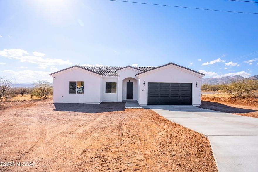 Stunning new residence available for purchase
on the Northeastern side of Rio Rico.
Enjoy breathtaking Mountain View's from this corner property. Three bedrooms, two bathrooms, and a two-car garage.
Approx. 1580 sq ft. living area underground electrical infrastructure, Quartz countertops stainless steel appliances 18x18 porcelain tile 10' ceilings 8' doors Alder wood custom cabinets. Extended rear patio, tile roof, Low-E 
vinyl windows A/C heat pump, Oversize Garage, water softner loop, All- electric