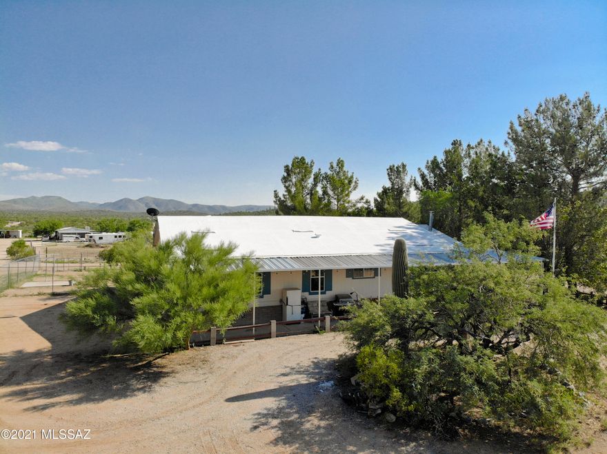 View this amazing 8 acre ranch house property! It's a former model manufactured home using 2x6 construction, upgraded insulation, and a great floor plan w/den off large primary bedroom. Complete with a wood burning stove, updated windows, gutters, 2 year old septic, newer well, dog run, and vegetable garden. Property amenities include a workshop, tuff shed, hay burn, tack room, over two acres of horse corral, full slab cement foundation, quiet gas pac outside, recently recoated roof, propane hookup for BBQ on front porch, full water (on float) and electric to pens, electric gated entrance, and mature tall trees. Room for expansion too! Plenty of usable space and well designed drives to avoid backing up trailers. Must sell with adjoining 2 acre listing. No HOA! View the 3D Walkthrough Tour.