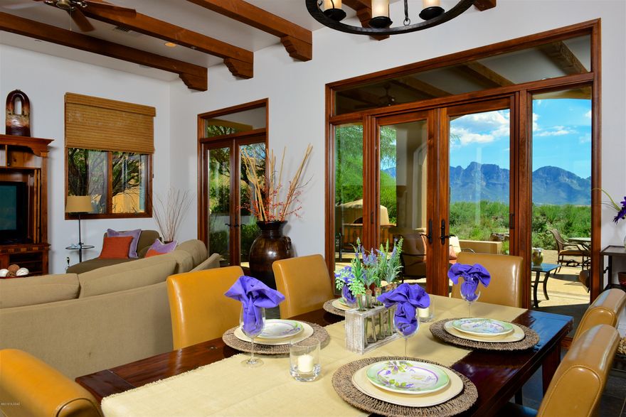 Simply amazing & forever PANORAMIC VIEWS!  Enjoy the best of Stone Canyon's Stonegate community with this gorgeous open Great Room layout enhanced with wood beams, slate floors, wood doors & trim, gas fireplace, gourmet Viking kitchen plus 3BR, Den (or 4th BR) & 4BA. You'll love the upscale amenities! Inviting entry courtyard leads to great room with marvelous mountain and city light views. Large covered south-facing patio is accessed via 3 sets of tall French doors (one w/Phantom Screen) and includes a built-in BBQ & outdoor Kiva gas Fpl. Master patio provides a lovely lounging area next to the very private west side of the property. Stone Canyon's championship golf course is ranked in top 3 in AZ. The award-wining private Golf Club is owned by Phil Mickelson & Steve Loy. Membership Req'd