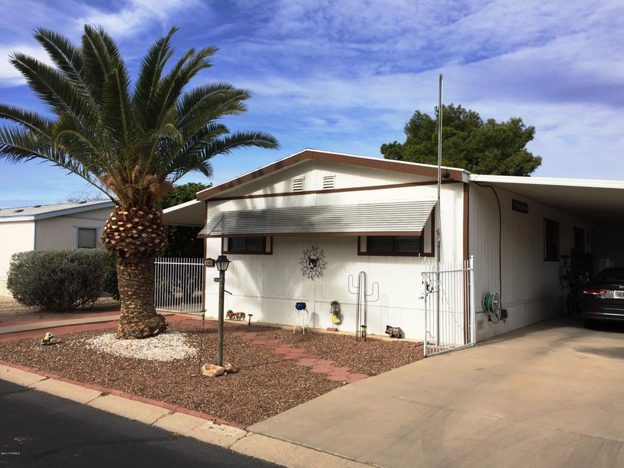 Very sharp well maintained home in popular Orange Grove Mobile Estates in NW Tucson, where you also own the lot.  Convenient to I-10, major shopping and N.W. Medical Complex.  Lot is totally fenced with drive thru gates, 2 large covered porches/carport and a large workshop/storage room.  HOA includes clubhouse, heated pool and spa, library, playground and basketball court.