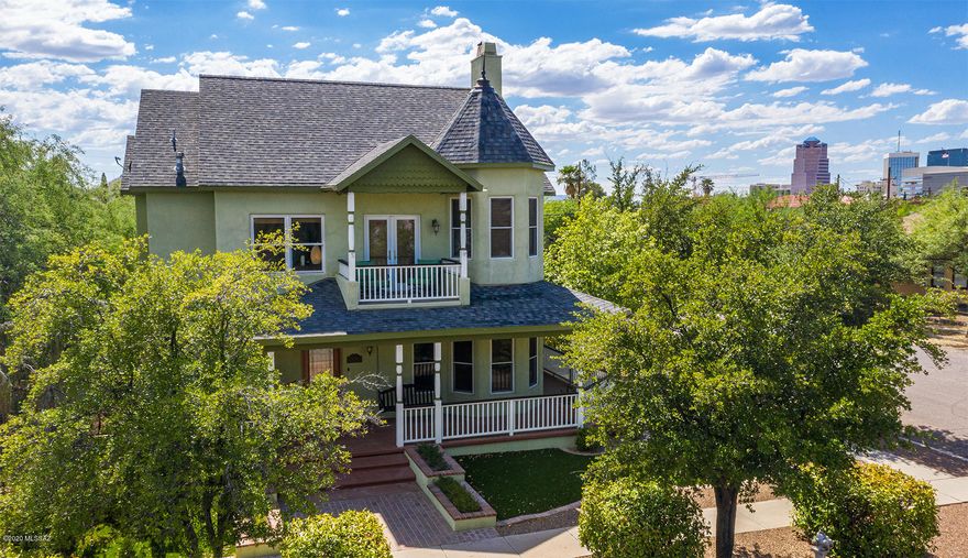 Located on a corner lot in Historic Armory Park. Enjoy  walking to all things downtown.  Built in 2005  w/meticulous attention to detail. History & modern convenience  meld together in stunning custom home. Beautiful great room floorplan, spacious kitchen, new quartz counter-tops. Island, breakfast bar & access to wrap-around porch. Real 3/4'' wood floors & wood case Anderson windows. 2 wood-burning/gas fireplaces, high ceilings, French doors & lots of light. 3BR's + small office/loft off master w/built-in bookcase. Perfect retreat w/mountain & city views, beautiful fireplace, sitting area, private balcony,  bath w/claw-foot tub & sep shower. Guest room w/private bath. Magical, private, hidden yard, built-in BBQ, fountain, mature trees & low care turf. Plus hard to find 2 car garage!