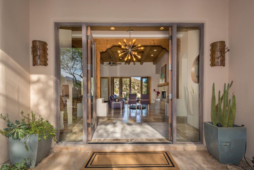 Step into this elegant & chic home nestled at the base of the Catalina Mountains in a sought after Catalina Foothills gated Community. Entertain in your chef's kitchen, complete w/dbl ovens, 6 burner gas stove top, walk-in pantry, & deep dbl SS sink. Resort style backyard with artificial grass, built-in BBQ, covered porch, Lrg pool w/Jacuzzi and separate spa. Soaring ceilings and full-size windows. 4BR/3BA home w/Travertine floors. Master Suite provides full mountain view, limestone step in shower, jetted tub & large closets w/built-ins. This home has so much to offer. Other highlights include; oversized 3 car garage, storage rm, 5 fireplaces- incl. Kiva & flagstone, GE & Bosch appliances, wood ceilings, skylights, laundry room, roll out shelves, under cabinet lighting & so more.
