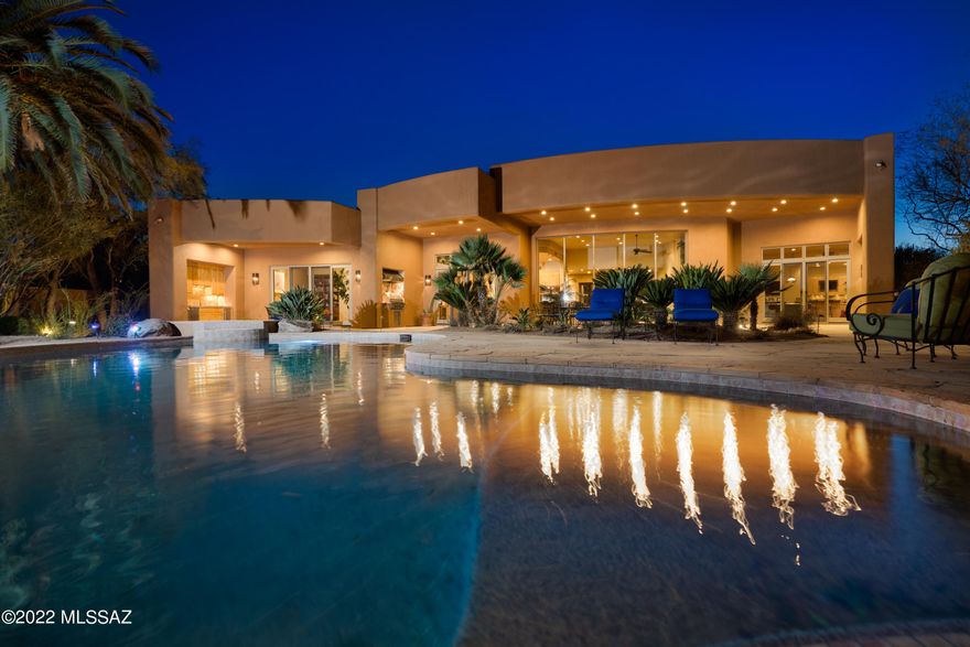 This extraordinary custom home is located inside the gates of Ventana Canyon Country Club. The home itself is privately gates on a secluded 1 acre parcel located between the 9th green of the canyon course and the practice facility. Enter the serene courtyard through massive metal gates and stone enclosure. Once inside you'll find aoaring ceilings, stunning mesquite wood & stone flooring, expansive windows that look out to the sparkling pool and mountain views. The chef's kitchen features viking appliances including 2 dishwashers, double oven, 6 burner cooktop with pot filler, warming oven & 2nd sink.