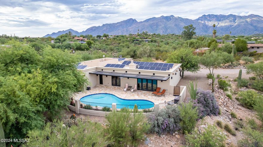 Nestled off River and Craycroft, this property blends privacy, convenience, endless mtn and city views with unsurpassed luxury and uniqueness. The secluded driveway leads to this tranquil desert oasis with all kinds of visible and invisible luxuries such as the solar driven 7 zone AC that lets you keep the temperature exactly where YOU want and saves energy costs. The custom chef's kitchen features a built-in refrigerator and metal countertops. The family room's see-through fireplace creates a warm ambiance flowing into the dining area. Sophisticated details include French locking exterior doors and a luxurious soaking tub in the primary bathroom. Outside, enjoy a patio, sparkling pool, covered seating, and cozy nooks offering stunning mtn and city views. Landscaped grounds with a custom gabion fence provide space for gardening. Close to fine dining, shopping, and recreation. Discover elegance, privacy, and modern amenities in this exceptional home. Catalina Foothills School District accepts students through open enrollment, in case schools are one of your criteria.