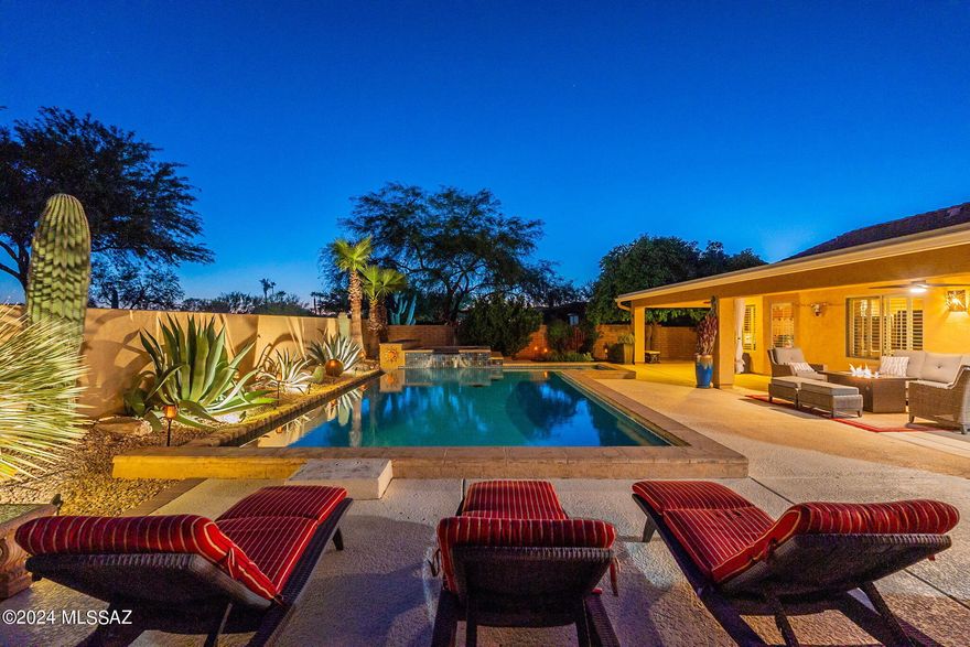 Stunning extended & updated three bedroom Laredo will captivate. Custom front gate, expanded paver & flagstone courtyard w/ fountain is perfect for entertaining or just relaxing. Exterior has stacked stone accents & gutters. New roof in 2018 w/upgraded underlayment. New HVAC. Custom front door with charming framed window, tile inlay entry, stacked stone media center w/surround sound & plantation shutters. Kitchen that is perfectly outfitted with whole house water filtration, 42'' cabinets, granite counters w/chiseled edges, full height stacked stone backsplash, eating bar, island, stainless appliances & extended dining area. Primary bdrm is spacious & offers extended bay window, primary bath is fully updated, primary walk-in closet is fabulous w/custom organizing system. Bedroom two offers a extended bay window & bedroom three is practical & perfect. Guest bath has been updated & offers a lovely walk-in shower. The outdoor living area is a showstopper w/heated, fresh water, custom, infinity trough pool & spa that takes center stage to this private oasis. The outdoor kitchen/bar offers a built -in grill, refrigerator & sink. The custom outdoor lighting, mature plantings, citrus trees of grapefruit, orange, lemon & lime add a special touch of lush landscape architecture that's fresh and inviting. The garage is extended in length& offers three bays, storage galore, utility sink & water softener. Welcome Home.