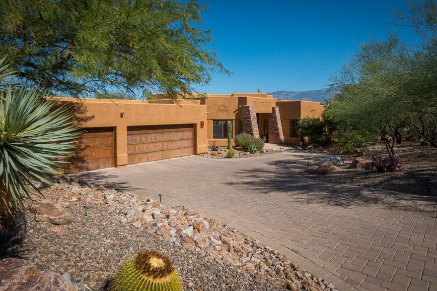 Exceptional contemporary estate situated on the ridge in Oro Valley’s sought-after Moonridge Estates, mixes elegance with casual living.  Rich finishes and attention to detail showcase outstanding craftsmanship of this 4 Bed/ 4 Bath/ 3264 SQFT estate.  The open flowing floorplan is complemented by soft textures and warm tones, showcasing the unobstructed Catalina Mountain views and taking advantage of filtered light.  Private + social outdoor spaces afford relaxation, as well as pleasure.  Gourmet Kitchen luxuries (by Davis Kitchen’s): Bosch + Wolf + GE Monogram + Master Chef SS appliances, island w/ prep-sink, roll-out shelving, ice maker, accented tray ceiling.  Master Suite: Travertine floors + vanities, glass tile accents, walk-in shower, jetted Kohler tub, custom lighting, ...... .... closets by California Closets.  All bedrooms include walk-in closets, with BDRMs 2 + 3 sharing a Jack-N-Jill bath w/ fine finishes.  Built-ins in den make for a cozy study/media room/office.  The backyard social space is equipped with a built-in BBQ, Kiva Fireplace w/ banquette seating, fruit trees, synthetic turf, Pebble-Tec pool + Spa w/ rock water feature, and lighting by Night Effects.  Please ask agent Property Details List for additional detailed information.
