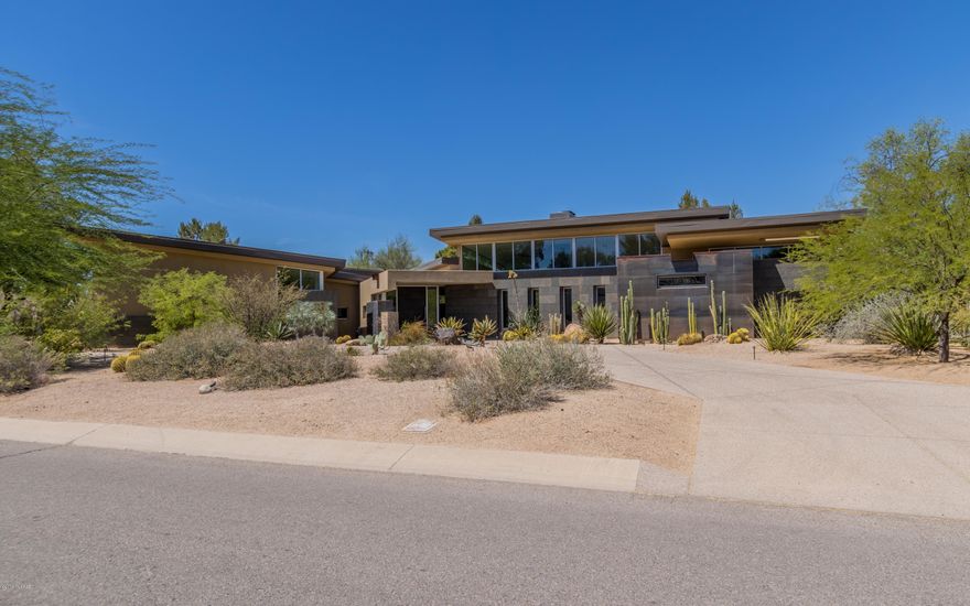 Masterful design meets modern luxury!  Impeccable attention to detail has been given to this exquisite contemporary retreat located with in the highly desired Tucson Country Club Estates.  Large floor to ceiling retractable windows line the home and welcomes the natural light allowing for the outside to meet the inside. The top-of-the-line chef's kitchen is clad with premium finishes and fixtures and armed with SubZero and Wolf appliances, three oversized wine refrigerators and a large walk-in pantry.  Each guest bedroom features their own ensuite, walk in closets and personal opening to the patio while the master suite contains a spa like bath and an oversized custom shelved walk in closet.  Entertain in grand style with generous patio space, a pool and spa, and outdoor fire place. Masterful design meets modern luxury!  Impeccable attention to detail has been given to this exquisite contemporary retreat located with in the highly desired Tucson Country Club Estates.  Large floor to ceiling retractable windows line the home and welcomes the natural light allowing for the outside to meet the inside. The top-of-the-line chef's kitchen is clad with premium finishes and fixtures and armed with SubZero and Wolf appliances, three oversized wine refrigerators and a large walk-in pantry.  Each guest bedroom features their own ensuite, walk in closets and personal opening to the patio while the master suite contains a spa like bath and an oversized custom shelved walk in closet.  Entertain in grand style with generous patio space, a pool and spa, an outdoor fire place, built in BBQ and a a putting green.  The self contained guest residence doubles as a pool home while the  four car garage contains cooling and an indoor basketball hoop.  Landscaped and spotless, your new home awaits!