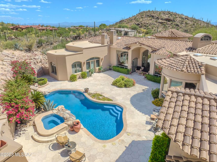 Spectacular home in the exclusive, gated The Canyons community.  This quiet and prestigious neighborhood is both secluded and close to everything, La Paloma, Ventana Canyon, La Encantada and more. Enjoy Stunning City Lights and Mountain Views from 3.3 acre lot. Home is the essence of elegance and luxury. DelBarco Stone and Bamboo flooring. Sculptured and Wood beamed Ceilings, Magnificence of Oversized Picture Windows throughout. Owner's Suite is Grand and Elegant; featuring Fireplace, Sitting Room, Dual Closets, Dual Bathrooms and Private Patio. All Bedrooms with EnSuite Baths. Temp Controlled Wine Room. Impressive Resort Style Backyard with Pool/Spa, Natural Rock Waterfall and Fireplace surrounded by Mountain and Rock Cliff Views for the Utmost of Privacy.  No detail has been overlooked!!