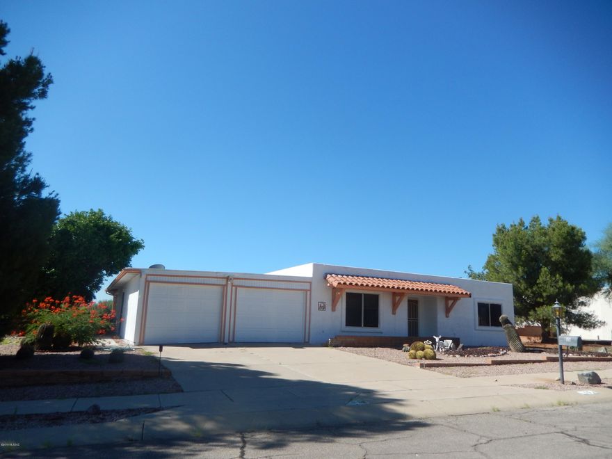 2 BEDROOM SUITES plus added room off master great for office. Great mountain views from the large covered back patio. Mature trees including grapefruit, orange, and tangerine. 2-car garage with workshop and storage. All tile floors and HVAC recently replaced. Just painted and ready for you! Added room may not be included in sq. footage.
