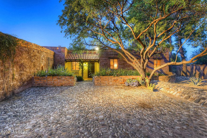 This extraordinary residence in the Tanque Verde Valley embodies the charm & elegance of Josias Joesler & the Arizona Inn. Local architecture enthusiasts will be captivated as they step into this quintessential Tucson estate home with outstanding craftsmanship & quality while still maintaining a sense of seclusion in the lush Sonoran desert. This three acre sanctuary is sited to offer vast, unfettered and dramatic view portals that stretch out to the Rincon Mountains. After you enter through the privately gated remote entry onto the cobblestone driveway, you are greeted by an expansive great room with polished concrete tile floors, Saguaro ribbed & wood beamed ceilings, large iron chandeliers & exposed brick which create an inviting & relaxing atmosphere to entertain both family & friends. This tranquil setting offers plenty of room to roam with four bedrooms, three bathrooms, office/work out flex space and an incredible sun room which is perfect for enjoying the vibrant sunrises & sunsets. Relax in the pool & live the Tucson indoor/outdoor lifestyle year round under the large covered patio that extends into the gardens with raised planter beds.  Numerous upgrades include: 19.5 SEER Daiken HVAC system with HEPA filters & Suntrac panel, roof recoated in 2020, pool renovation in 2019, new garage door opener & door in 2019, new water heater in 2020, 770' of property fencing installed with new gate, new landscaping 2021, new state of the art irrigation system (Rainbird Smart 4 Zone & two Racchio Smart 16 Zones systems) - and much, much more.  Truly a remarkable residence.