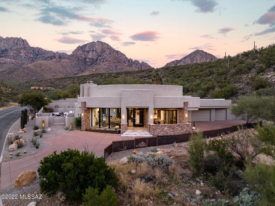 Exceptional desert contemporary custom home located on a pristine over 3-acre lot in sought-after guard gated La Reserve in Oro Valley. This elevated homesite delivers extraordinary views & privacy coupled w/ thoughtful design & flawless execution for the ultimate in desert living. 3 bed + office, 3 bath home. Major interior renovation completed by the current owner has taken this 2006 home to next level. Upon entry you are greeted by walls of windows that flood the space w/ natural light & capture impressive mountain & city views. The flat-screen TV descends from the ceiling above the great room DaVinci fireplace, providing space to display art when TV is not in use.  Bright & spacious, modern kitchen w/ custom cabinetry, quartz countertops, large center island w/ dbl sink MORE prep sink w/ disposal, 2 breakfast bars, Wolf, Viking & Sub-Zero SS appliances opens to the great room for ease of entertaining & enjoying time w/ friends & family. Large walk-in pantry w/ SS wine cooler & additional refrigerator. Formal dining room w/ built-in buffet & spectacular city views. Massive retractable glass doors w/interior & exterior automatic shades lead to resort-style backyard w/ pool, spa, waterfall & unobstructed views of the Pusch Ridge & seating areas w/ city views.  Effortless indoor/outdoor living for gatherings small & large. 
Split bedroom floor plan has an impressive master suite w/ office area, truly luxurious spa-inspired master bath w/ modern soaking tub, separate shower, his & hers closets w/ custom cabinetry. 
Guest bedroom wing has a private en-suite guest bedroom w/ upgraded bath & 3rd bedroom currently being used as a work-out room. Versatile additional bathroom is ideally located for pool use and guests.  Large separate yard area w/ desert landscape & turf. Exterior finishes merge together stacked stone, metal & glass to compliment the surroundings. Oversized 1069 sf 3-car garage w/ sink & storage. For those looking for privacy and serenity & very close proximity to the best shopping, restaurants, world-class golf resorts, hiking, biking & the aquatic center in the Oro Valley area, this location is unrivaled.