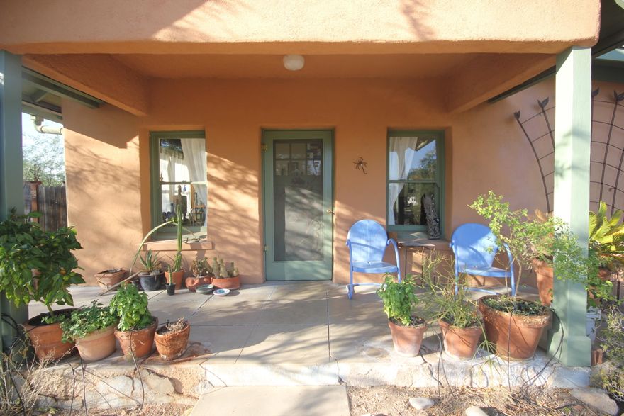 Adorable 1930's vintage home with original details.  Wood floors, double hung windows, wood framing and  wood paneled doors.  Exposed adobe brick in 3rd bedroom.  Thoughtful addition in 2006 added master suite, laundry room, walk in closet, french doors to lovely covered patio.  Metal roof and brand new HVAC system.  Large lot with water harvesting, low care native plantings and walkways among large mature trees.  Mountain views in the background. Tankless water system, upgraded electrical and Summit fridge.  BONUS detached 15' x 11' adobe studio, with electric, water, insulated, not included in square footage. Vintage stove/oven conveys as is.
