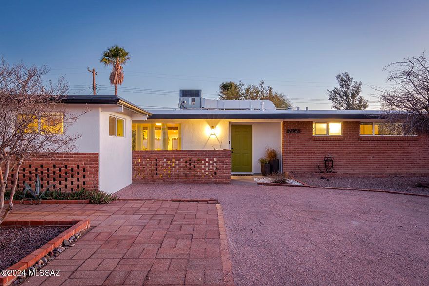 Step inside this well cared for mid-century ranch style home in a quaint Eastside neighborhood. Updated with carefully considered designer touches throughout. This spacious home provides a main living area that consists of a great room, breakfast bar, off-kitchen sitting area and a proper dining room. Just off the great room is another special bonus or Arizona style room with lots of light and windows that look out to the manicured backyard. The home has a nice flow that leads into three bedrooms and two full bathrooms on the westside and another room that could be used as a bedroom or an office, studio or workout room. Whatever suits your specific vision or needs as a buyer.