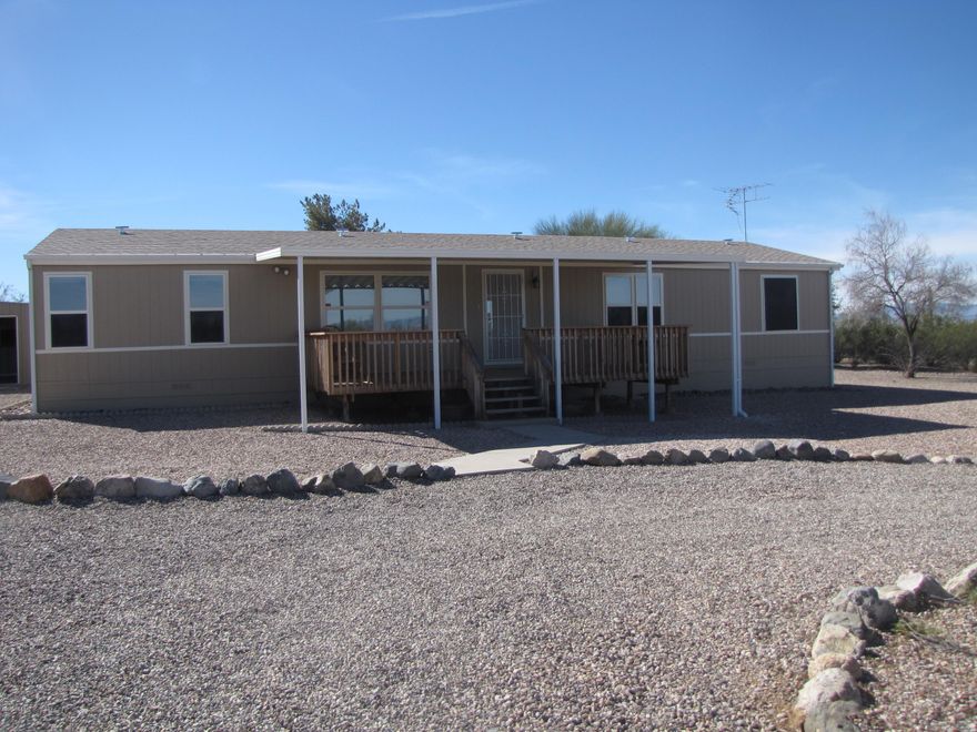 Very clean freshly painted.  3 bedroom, 2 bath home on 4 acres.  Large kitchen with island.  Laundry room with washer & dryer.  Covered decks front & back.  Large detached garage plus 2 storage sheds.  Fenced all around.  Mountains, sunrise & sunset views.  Rent includes water.  Propane & electric paid by tenant.