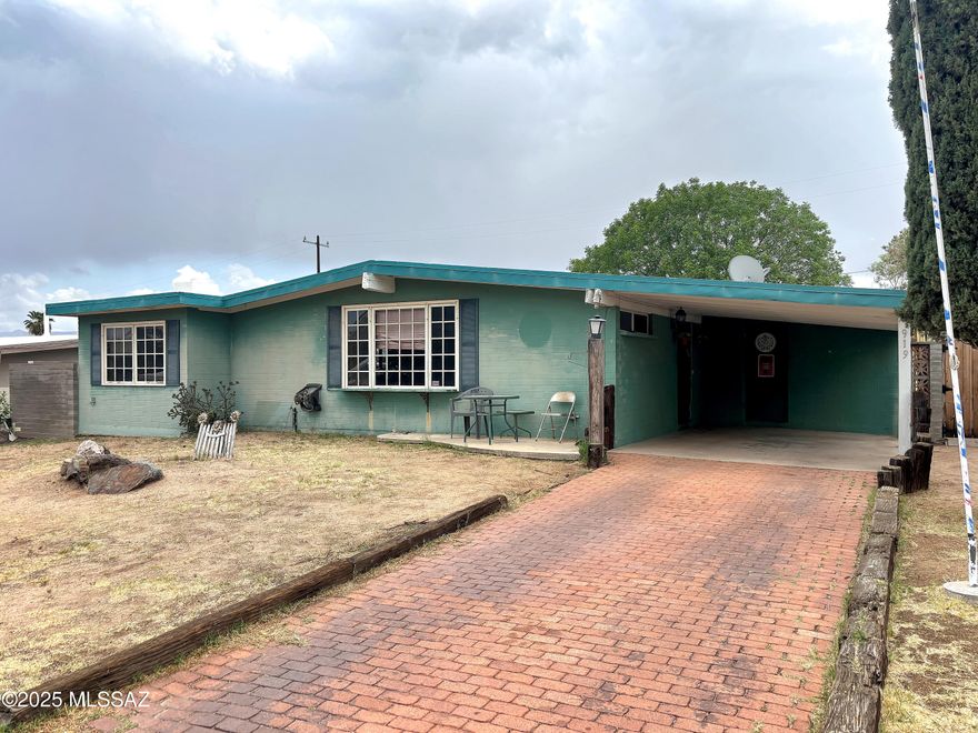 Charming 3-bedroom, 2-bath home with great potential, ready for your personal touch. Features include a spacious, block-fenced backyard with alley access, two unique sheds (a ''he shed'' and a ''she shed''), and a welcoming paver driveway. Relax on the covered paver patio and take in beautiful mountain views. Some TLC will make this home truly shine.