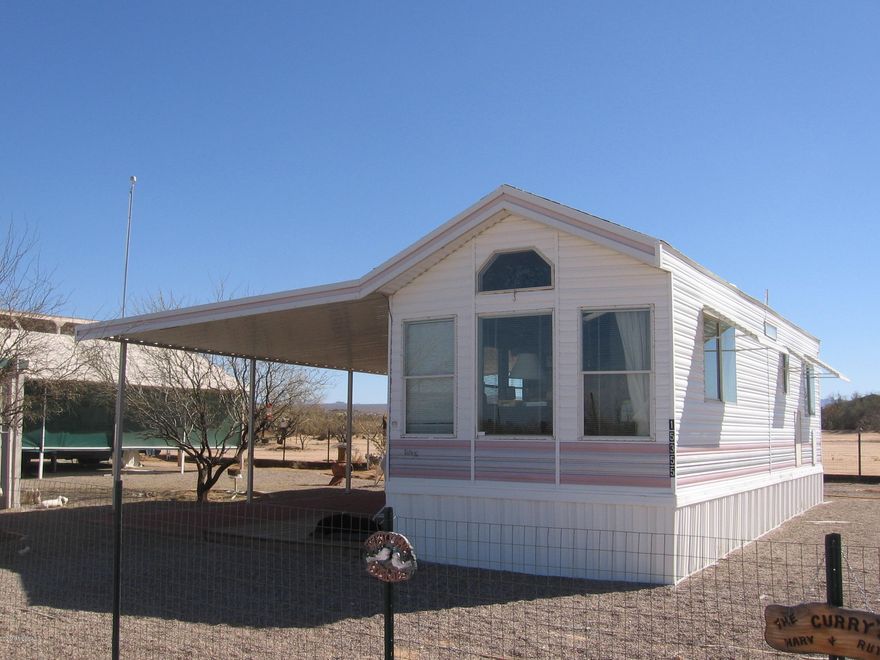 Looking to downsize in the country and have your RV? This is the perfect spot for seasonal living or if downsizing! Local stores make shopping a breeze! Walking distance to church, daycare, feed store, meat market and short drive to community center. Home is a park model and boasts an amazing covered patio for your BBQ's! There is an outbuilding that has a full bedroom, with sink, commode across the way is the laundry and shower room. Both buildings are site built with heat/AC, water and electric. There is a large covered RV parking space as will with all the hookups! Don't let this one get missed! Possibilities are endless! You need to see it today! Auto drip water for trees, lemon trees. 2 RV hookups!