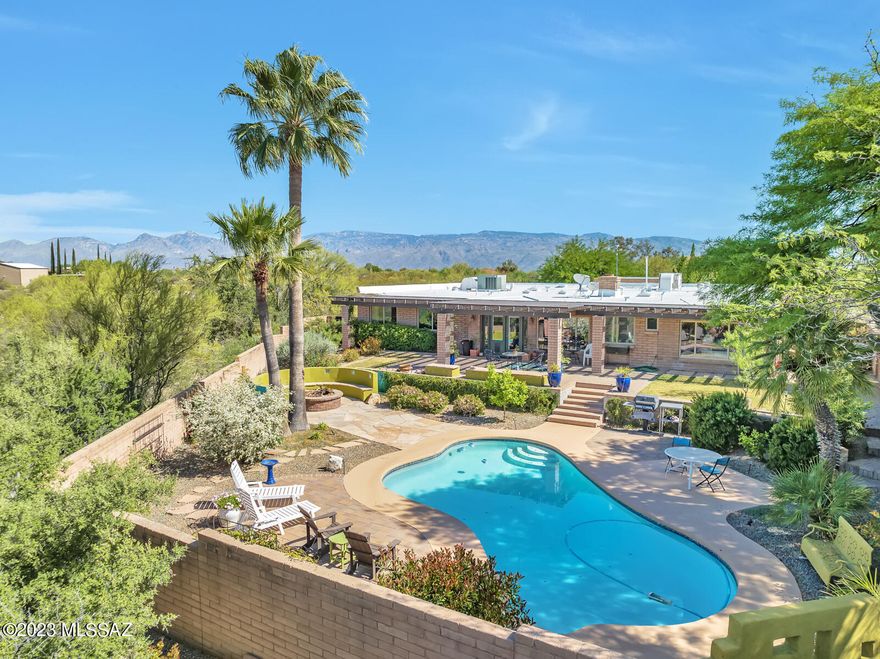 Charming and Artistic Contemporary Territorial nestled on 4.76-acres of natural desert in the Rincon Mtn foothills. ¼ mile from Saguaro Nat'l Park East. Chef's kitchen with granite countertops, gas cooktop & large walk-in pantry. Large Great Room, split bedroom floor plan. Updated landscaping with dramatic low voltage lighting, firepit, pool and poolside areas, expanded front courtyard. Lots of space for additions, horses and parking. An attached 2-car garage plus a detached temperature controlled 2-car garage/workshop, both with insulated ceilings. Well maintained home with thoughtful touches and additions, including Venetian plaster, glazed walls, and illuminated tray ceiling in master bedroom. New HVAC 10/2022, 3yr warranty on the newly 10/2022 coated roofs & freshly recoated pool deck
