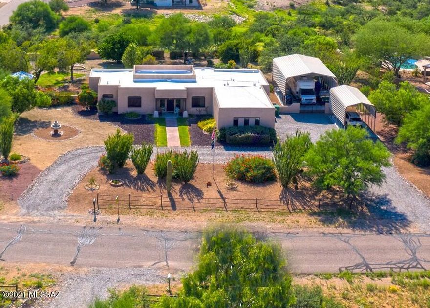 Lovely view home nestled on over an acre of property on a paved street in Vail. allows for horses and RVs on site. There is a 3 car garage and 2 carport slabs. One is 12 x 25' and one is 23 x 32' with 30 amp RV hookup. The property is only 15 minutes to major shopping and has Vail Water Company, many citrus trees, a 10 x 12 Tuff Storage Shed, & spa. Home boasts security windows & screens, ceiling fans, a full length back patio with access from master bedroom and living area. The current piano room could be formal dining room. Master bedroom has 2019 carpet, tub and shower, and a large closet. Both dishwasher and HVAC were replaced in 2019