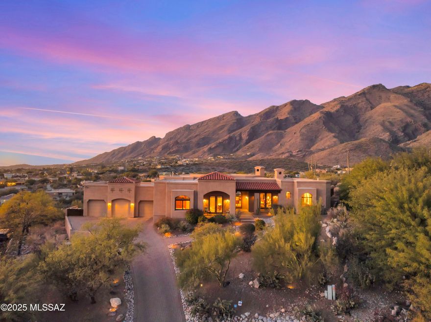 Perched atop one of Alta Vista's highest cul-de-sac lots, sits this charming Greg Simmons/William Diamond custom built home made for entertaining. Enter the great room & be wowed by the wall of windows framing the majestic Catalina Mountains. A chef's kitchen features top-of-the-line appliances & the largest island I've ever seen! There's a formal dining room (city/mountain views), butler's pantry, wine room & office with custom built-ins. The primary suite has a gas fireplace, large bath with separate vanities, & 2 patios offering mountain views to the north & city views to the south. 2 guest rooms (1 en-suite) both have french doors to a shared patio for city views. A den can be used as a tv room/workout space or extra bedroom. 3 car garage. Pebble-tec saltwater pool & spa. Owner/Agent