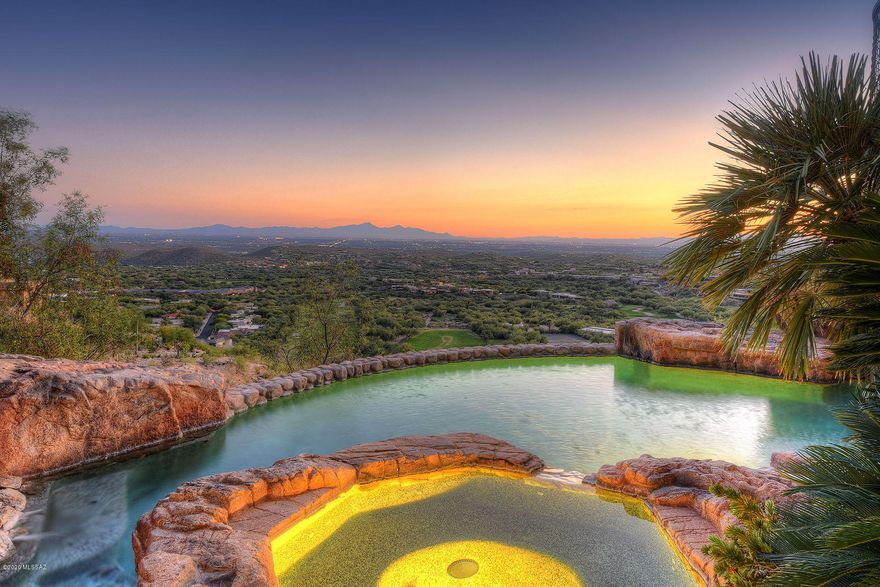 Exquisite Desert Inspired Design. Sophisticated 11539 sq ft 7 bedrm/8 bath estate. Nestled in the mountain enjoy one of the best lots in Ventana Canyon overlooking the city of Tucson on 2.3 acres. Commercial build w/highest quality materials, coffered 24' ceilings, custom 10' knotty alder doors & natural materials throughout. Well designed floor plan ideal for families, visitors, multi-gen living or corporate events w/adult living area on one floor, mother-in-law suite & 2nd guest quarters. Grand living room welcomes you w/ incredible panoramic floor to ceiling glass windows showcasing all of Tucson. Home completely updated w/open chef kitchen, luxurious baths & storage. Huge owners suite w/his & her baths, walk-in closet & personal gym. Outdoor oasis w/resort-style pool/spa. See More tab. New top of the line Fischer & Paykel ovens & 5 burner gas range. Enjoy modern conveniences of Sub-Zero fridge, freezer & refrigerated drawers, warming drawer, prep sink + 2 dishwashers. Incredible attention to detail with tons of storage, cozy breakfast nook, office space, laundry unit & delightful mud room. Sound dampening panels in Entertainment Area includes screening room, billiards room, custom historic wood bar with stained glass, wine cellar, sub zero fridge & 2 freezer drawers. You will also find patio with lush greenery, outdoor fireplace, built-in BBQ & views of the Tucson Foothills Catalina Mountains. The Owners Retreat creates a luxurious atmosphere w/ panoramic views, private patio & large personal gym. Spa like master bath boasts dual vanities, custom jetted tub, oversized walk-in shower, his & hers water closets. Massive custom closet with built-ins & safe room.

Executive office area also resides on the main level with stunning knotty alder built-ins , specially made granite & rock U-shape desk. The second office on the main floor would be an ideal setting for "home schooling" with 6 workstations & Top of the Line High-speed internet. The multi-level south patio is a true outdoor oasis which is ideal for indoor outdoor living w/ built-in BBQ, large covered patio & bar + 1/2 bath. Enjoy the endless views in your resort style pebble tech pool, separate spa & multiple water features. Speakers & ready to install misting system creating an unforgettable resort like experience for your family & guests. Custom wood elevator takes you to the lower level which is great for kids or extended family & includes 4 private bedrooms, 2 den spaces, 2 updated bathrooms, flex room & laundry room. Mother-in-law suite has separate entrance both to exterior and main house with bedroom, family room, breakfast bar, kitchenette & full bath. Every inch of the home is well thought out. 6 car garage + golf cart garage includes heated & cooled workshop + an additional 17 parking spaces.

A 24 Hour attended Guard Gate provides security for your family and estate. https://www.ventanacanyonclub.com This home has been engineered with low maintenance in mind, masonry construction, steel roof and natural stone. Great circulation space can easily handle many people 50-100+ for large family gatherings or corporate events. Value of the land and lot preparations easily over $1M itself. The smart design has the entire adult living area on a single floor. Resort style front and back yard designed by award winning John Stropko/New Desert Gallery. A solid feel and a peaceful natural ambiance await your further exploration.
Everything has been done & done right!!
