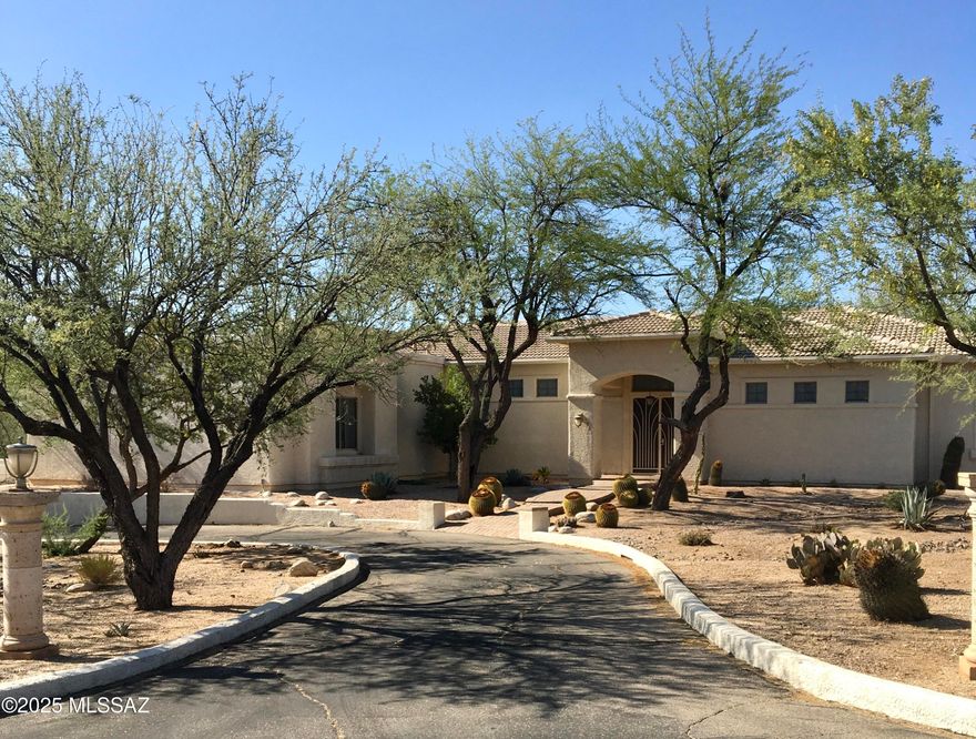 Beautiful one owner custom built home with registered private well on 4 acres of horse property!Dead end street backs up to LaMariposa Resort and some of the best riding trails in Tucson.
Foyer opens up to great room with mountain views &huge back porch complete with outdoor kitchen and ceiling fans,great for entertaining! Split bdrm plan with access to back porch from master suite. Master has well thought out very large walk in closet,& beautiful master bath with dual shower.
Custom kitchen with pull outs in pantry and most cabinets, prep sink, and little roll top desk. There is a very nice size laundry room with sink and plenty of cabinets that opens up to spacious 3 car garage with built in workshop, cabinets, &extra storage. 
This is a rare chance to own in this 4 home enclave!!