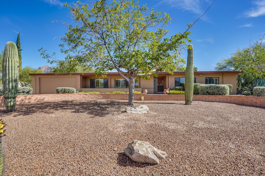 Great opportunity to own a beautifully updated 4 bedroom 2 bath home in Casas Adobes. No shortage of living space here with a formal dining room featuring oak hard wood flooring, living room and great room off the kitchen. Great room features a wood burning beehive fireplace. New Shaker Style kitchen cabinets, granite counters, custom back splash, stainless steel appliances, Master suite features a private retreat area with private backyard entrance, double closets, 3 additional bedrooms are generous in  size. Large laundry room with overflow pantry storage. Attached 2 car garage, Pavered circular driveway ushers you into this private mountain view lot featuring a pool, built in outdoor kitchen, beehive fireplace, basketball court, Covered RV parking/carport..