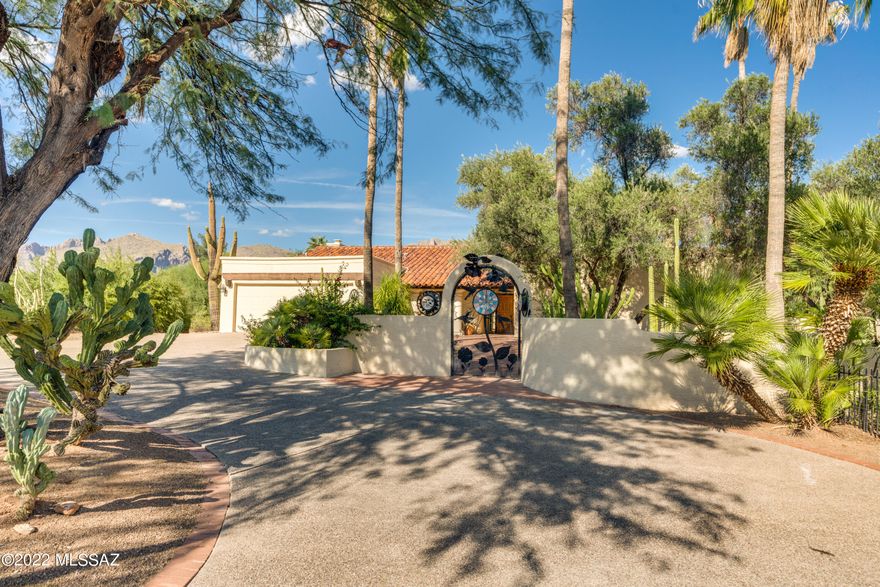 Entertaining Dream Home: This was the model home for the subdivision! Fireplaces, separate wine cellar w/ AC, fire pit, wet bar, outdoor kitchen, lots of natural light, pool, spa & numerous outdoor living spaces set among covered patios, shady trees & established hedges for privacy. Solar is a modern upgrade in this time capsule home w/ new concrete overlay floors (no carpets!) & an abundance of natural wood. New paint inside & out, dual cooling and with 5 bed/3.5 baths you'll have plenty of space! Convenient to La Encantada shopping, Catalina HS and more. This home has personality & character galore and is just waiting for you to bring your own style to make it your perfect home escape.