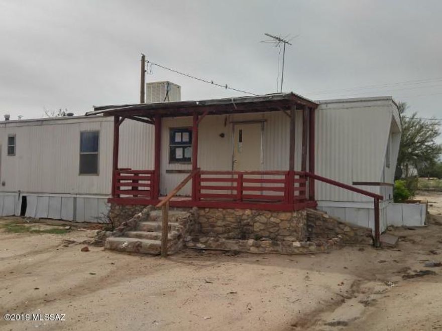 2 Bed, 1 bath manufactured home located in Tucson, AZ. This fixer-upper offers great potential sitting on a rural 1-acre lot giving you plenty of privacy, yet only 20 min from downtown Tucson. The home is in need of updates and repairs before move in ready, once complete this will make a great starter home.Property is sold in ''as is'' condition and ''where is''. Seller does not prorate taxes or pay delinquent taxes. Buyer pays all closing costs including, but not limited to any and all transfer taxes, title, legal, and recording fees. Seller has no knowledge of condition. It is the responsibility of the buyer to do all research pertaining to this property.