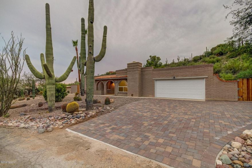 Breathtaking Mountain Views, inviting decorative paver entry, and meticulous desert landscape guide you into this tastefully Remodeled Home. Spacious open floor plan, gorgeous flooring, soothing palette, upgraded lighting, cozy brick fireplace w/hearth seating area, ceiling fans, and large arched front window. Stunning new kitchen features quartz counters, breakfast bar, glass subway tile backsplash, and white wood cabinets with hardware. 2 Sets of Arcadia doors to patio. Interior laundry room. New carpet/padding in all bedrooms, ample closets, 2 upscale baths with designer mirrors, tile, fixtures, and lighting. Fantastic backyard setting with covered patio, RV Gate, and incredible blue skies. Plenty of room for a pool & toys! Owner/Agent.