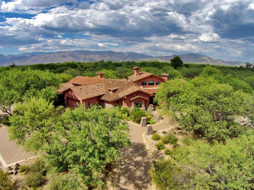 Find peace & tranquility in this gated & serene home in the desirable TV Valley. Mesquite lined winding entry on sub- dividable 11+ acres. Quality thru out this custom 4BR/3BA main house. Exquisite design, no detail forgotten. Designer kitchen w/granite, Alder cabinets, dual SubZero drawers, Monogram refrigerator, 8 Burner Decor cook top & wine cooler. Hardwood, concrete & Italian Porcelain flooring. Spacious & luxurious master suite w/2 walk-in closets, heated floors, private patio w/Apricot Trees, bonus room & FP. Charming loft, back patio is an entertainers delight w/outdoor kitchen, FP, tongue & groove ceilings. Private 2BR/2BA guest house has full kitchen, laundry room & carport. See attached amenities list, floor plan & proposed lot split for more detail. Room for horse facilities.
