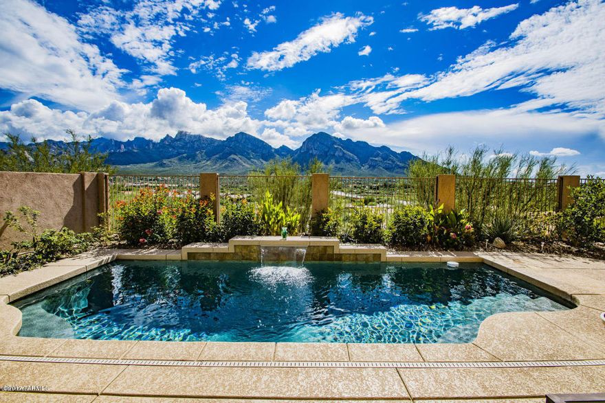 ABSOLUTELY STUNNING UNOBSTRUCTED VIEWS OF CATALINA MOUNTAINS & CITY LIGHTS FROM YOUR REAR PATIO & PEBBLE TEC POOL!! Sitting atop the ridge, this home is Upgraded to meet your Highest Standards...Gourmet kitchen with Granite Countertops & backsplash, double oven, 42'' upper cabinets, under cabinet lighting, 20'' porcelain tile, Karastan Carpet in bedrooms. Extended garage & front bedroom. Cozy Fireplace in Greatroom. Split bedroom floorplan creates a wonderful private suite with bathroom. Master suite has lovely walk in closet, double sinks, oversized walk in shower, and soaking tub in Bath. Gated courtyard and beautiful security screen door enhance the charm & warmth of this fabulous home.