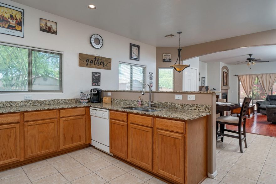 Fabulous 3 bedroom 2 bath single story home on a corner lot. Open floor plan offers a large kitchen with extensive cabinet and counter top space. Kitchen and dining room are open to the family room. Family room features a gas fireplace and sliding door out to the pavered back yard. Master bedroom has a large walk in closet. On the opposite side of the house are the 2 guest bedrooms and laundry room. Conveniently located to the the main Sahuarita clubhouse, pools, splash pads, fitness center and community center, local dog parks, beautiful lake and playing fields.  Granite counter tops, wood floors and ceiling fans thru out. Perfect place to call home!