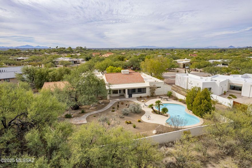 This spacious home in NE Tucson provides an elegant and peaceful setting with amazing views of both the Catalina and Rincon Mountains located in an established neighborhood of well appointed homes on large lots. A walled front courtyard with a soothing fountain welcomes you into a spacious and dramatic light filled central living space with soaring tongue and groove ceilings, a dramatic double sided fireplace and a view to the backyard pool and Catalina Mountains.  The permitted addition of 762 square feet with a separate entrance and separate patio is ideal for an art studio, guest quarters or office area. The home has been re-roofed, the pool decking recoated, a new double gate and new garage door opener installed.   NO HOA. Transferrable termite warranty. The  price per sq. ft. is dramatically lower than recents sold homes in this neighborhood which allows buyers to do any upgrades they desire.

For outdoor enthusiasts Agua Caliente wash and hiking is within walking distance with trails to Agua Caliente Regional Park, a unique 101-acre park that features a perennial warm spring and pond that is home to an exceptionally rich mix of plants and animals.

Shopping, restaurants, horse boarding facilities all within a 10 minute drive.

WONDERFUL OPPORTUNITY IN A GREAT AREA!