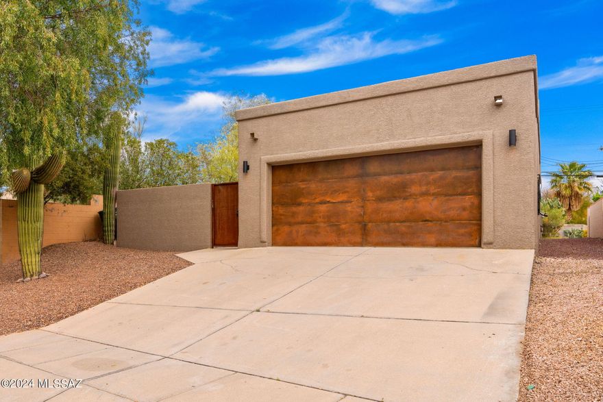 Immaculately renovated residence nestled on Tucson's east side. 

All white cabinetry with a sleek black kitchen sink and exquisite Calacatta quartz countertops harmonizes flawlessly with stainless steel appliances. Luxurious bathrooms boast modern floating vanities, indulgent waterfall shower-heads, and chic matte black fixtures. Enjoy the convenience of a two-car garage, newly epoxied and featuring a striking rusted metal door. The enclosed entrance envelops the home, adorned with turf, elegant pavers, and accent lighting. 

Conveniently situated approximately 15 minutes away from Tucson Country Club and Randolph Dell Urich Golf Course. 

Don't miss out on this charming residence featuring vaulted ceilings and the added bonus of no HOA fees!