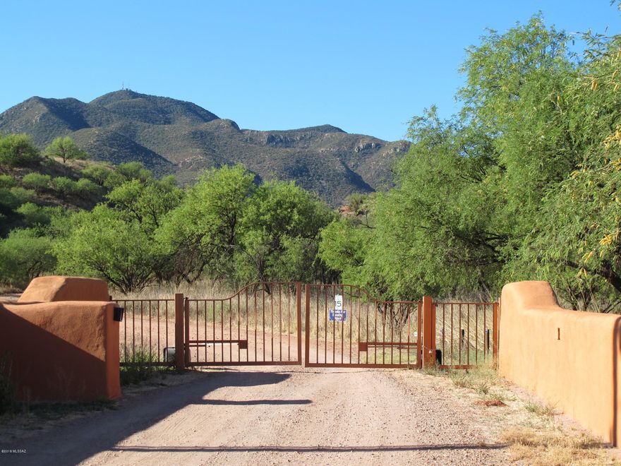 Exquisite, Exclusive and Extraordinary!  This large acreage features 360 degree views of glorious mountains. The infrastructure for the Wetlands Septic/Water was designed by Southwest Wetlands Group, Santa Fe NM. The large water system was designed for a much larger capacity than is now in use. The outbuildings consist of an ''AS IS'' house 1226 , a large Guest Quarters with 10 bedrooms and 6 bathrooms 2350 sq ft ''AS IS'' and a Sacred Temple 324 sq ft. This property has been preserved for the last 25 by a non-profit  organization. Most all of the land has its original grasses,trees and foliage. It's a pristine open space location. The current owner had a special use permit with the County for ''a clinic for human use''. This was granted in 1993. This property has great potential.